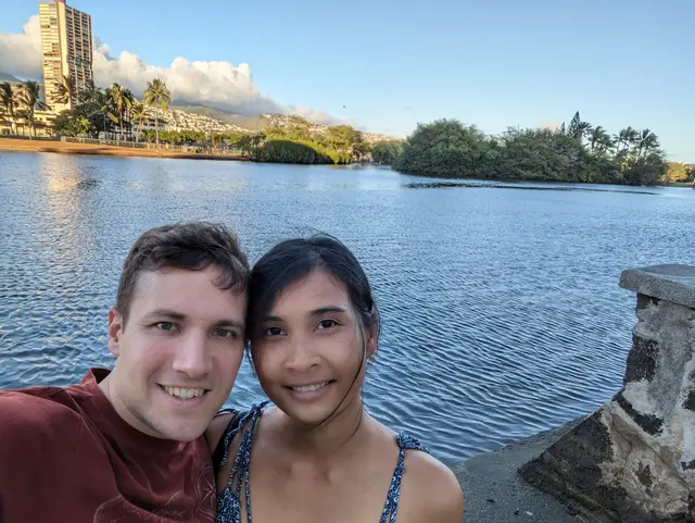 ggraph of Chris and Emily in front of calm water in Hawaii