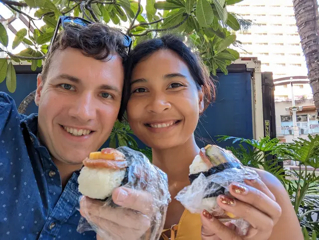 ggraph of Chris and Emily holding spam musubi